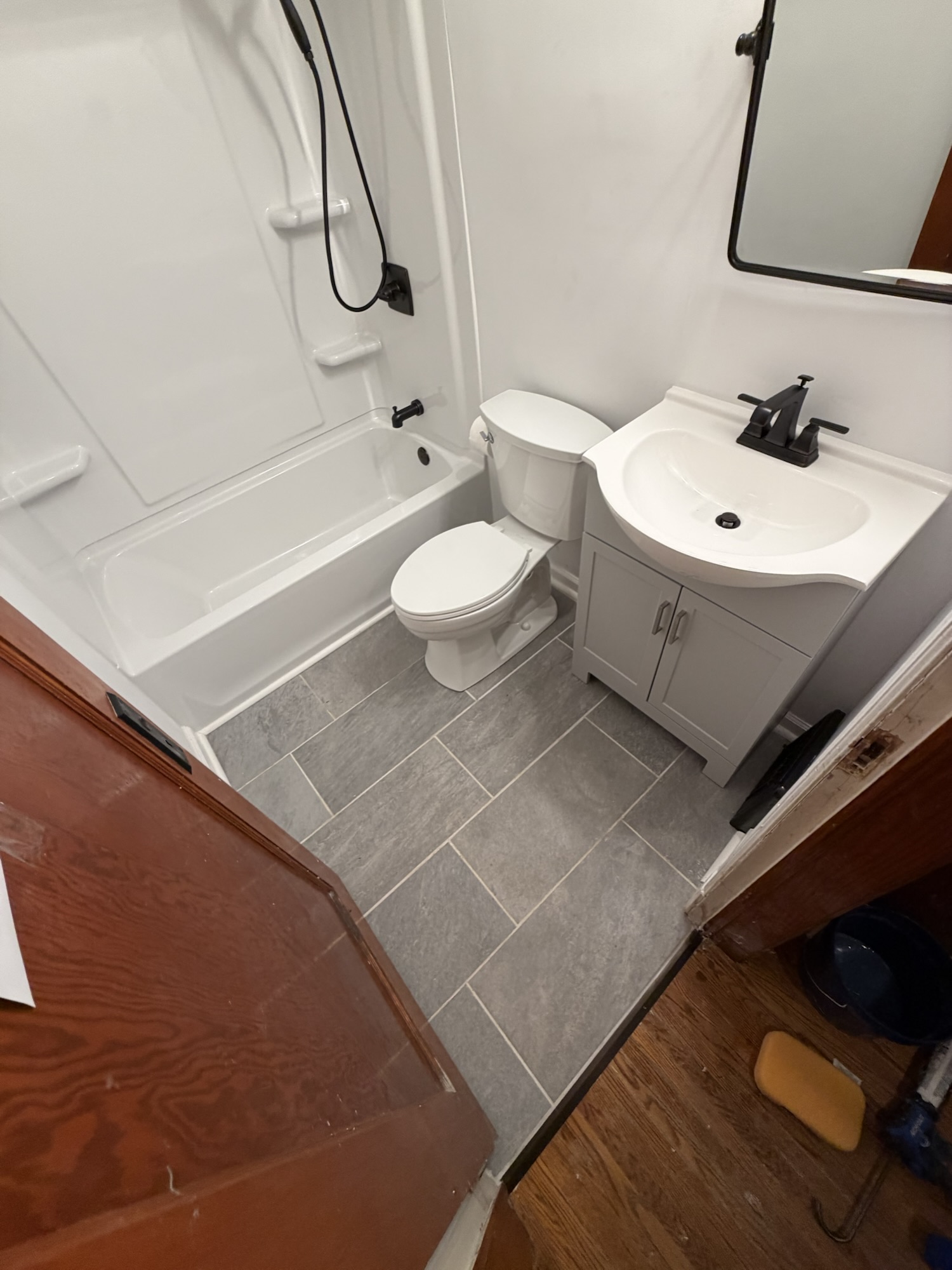 Finished bathroom remodel with tile floor and new vanity in Evansville Indiana